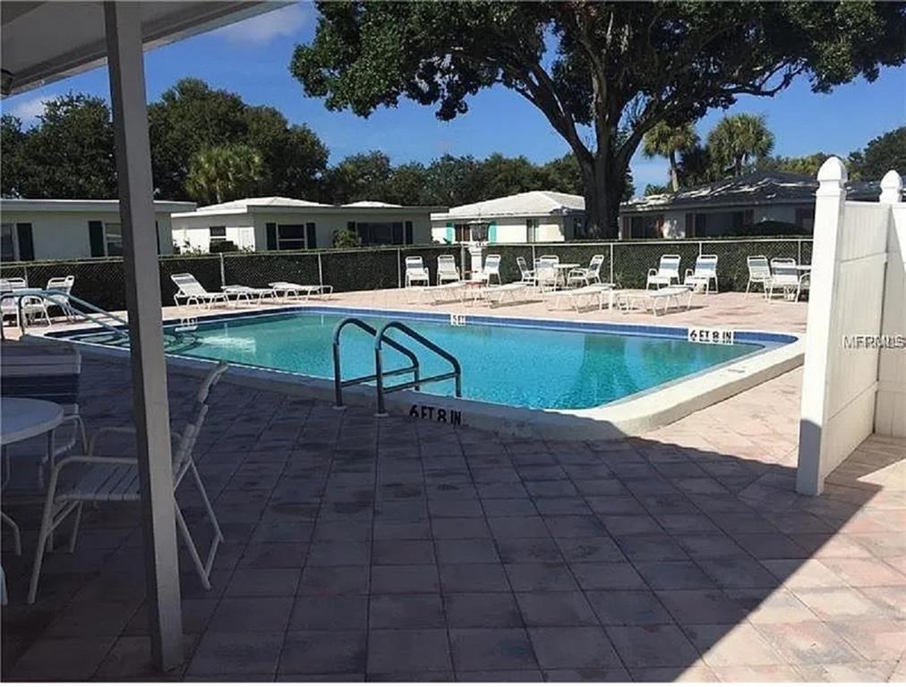 3900 Roxane Boulevard, Unit 10A Sarasota, FL 34235 - Photo 9 of 10 a view of a swimming pool with a patio