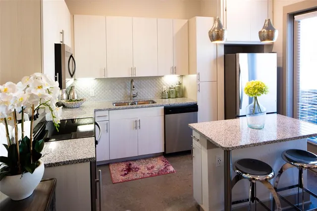 a kitchen with a table chairs and a refrigerator