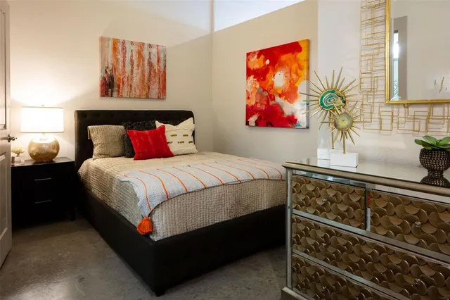 a bedroom with a bed and wall painting