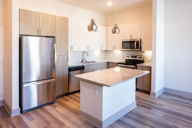 a kitchen with stainless steel appliances a refrigerator and a sink
