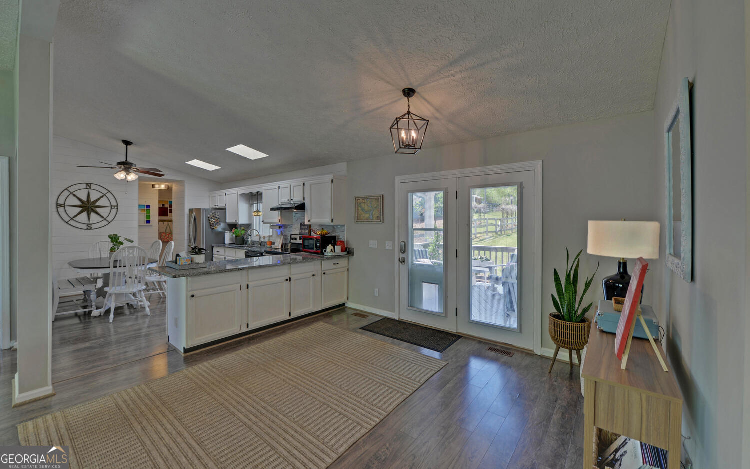 809 Glenn Ferry Road Fair Play, SC 29643 - Photo 15 of 78 a kitchen with a refrigerator and a table chair