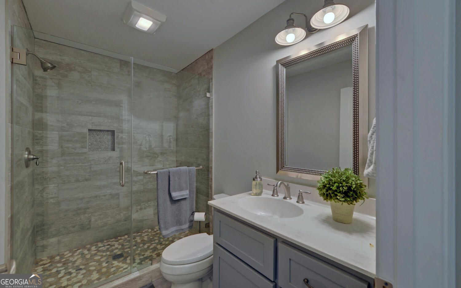 809 Glenn Ferry Road Fair Play, SC 29643 - Photo 34 of 78 a bathroom with a granite countertop sink a toilet a shower and a mirror