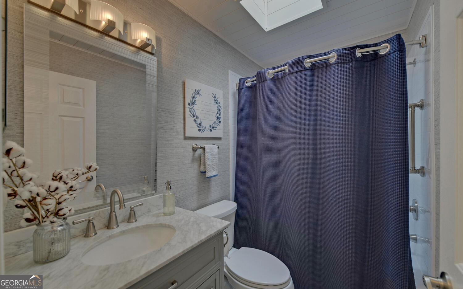 809 Glenn Ferry Road Fair Play, SC 29643 - Photo 46 of 78 a bathroom with a sink a toilet a mirror and shower curtain