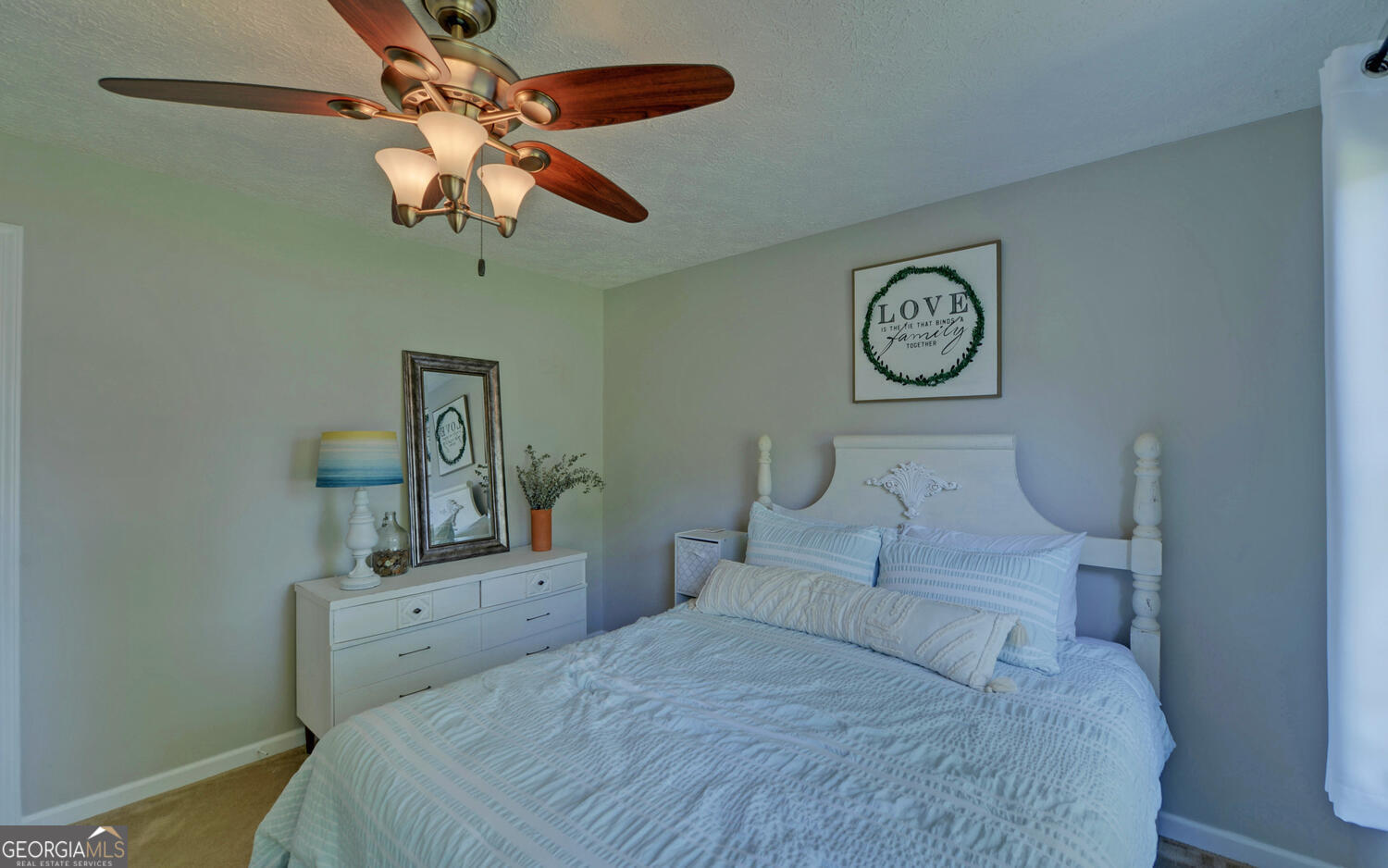809 Glenn Ferry Road Fair Play, SC 29643 - Photo 50 of 78 a bedroom with a bed and a chandelier