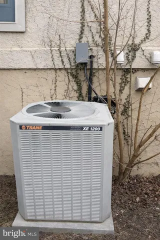 a front view of a house with a garden and trees