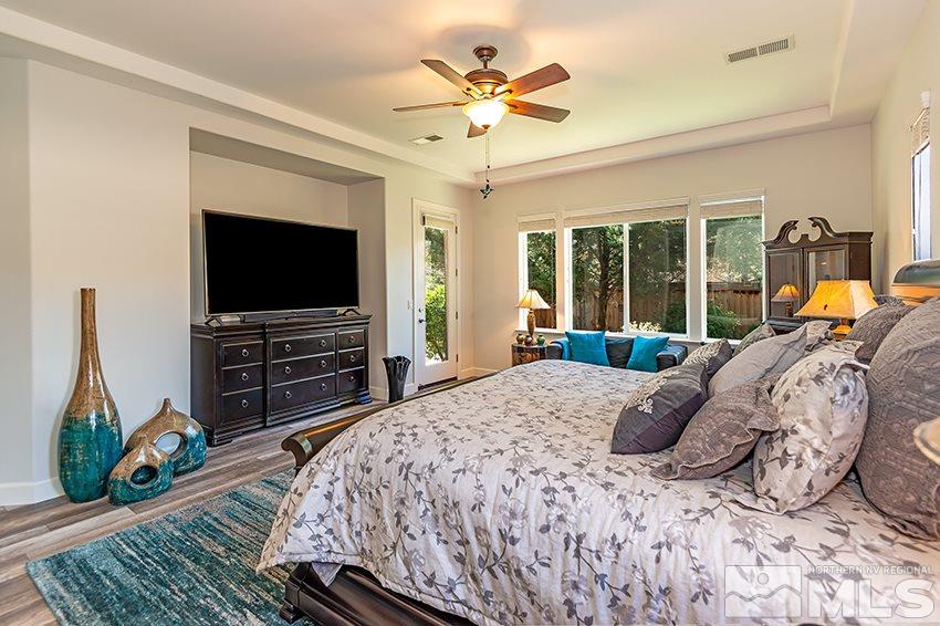 2675 Colmar Court Reno, NV 89521 - Photo 13 of 25 a bedroom with a bed and a flat screen tv