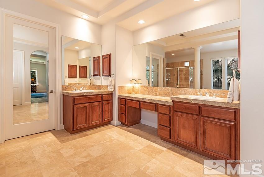 2675 Colmar Court Reno, NV 89521 - Photo 14 of 25 a large bathroom with a granite countertop double vanity sink a mirror and a bathtub