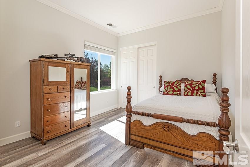 2675 Colmar Court Reno, NV 89521 - Photo 16 of 25 a bedroom with a bed and a dresser