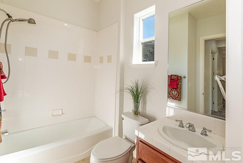 2675 Colmar Court Reno, NV 89521 - Photo 17 of 25 a bathroom with a sink toilet and shower