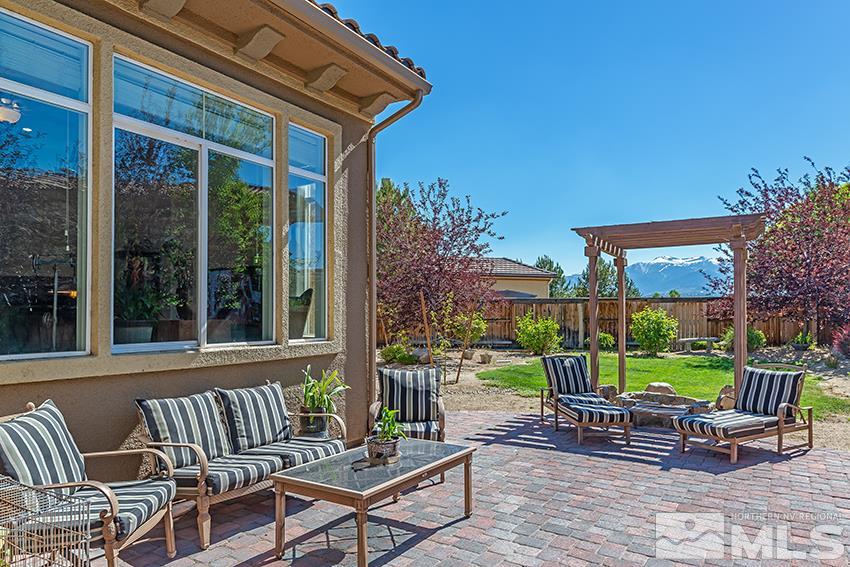 2675 Colmar Court Reno, NV 89521 - Photo 21 of 25 a view of a chair and tables in the patio in front of a house
