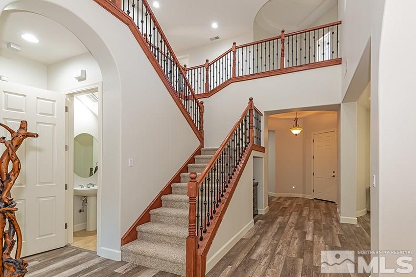 2675 Colmar Court Reno, NV 89521 - Photo 4 of 25 a view of staircase with lots of frames and wooden floor