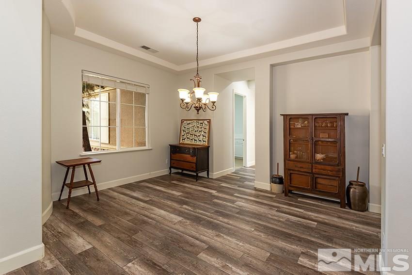 2675 Colmar Court Reno, NV 89521 - Photo 5 of 25 a view of a livingroom with wooden floor and a ceiling fan