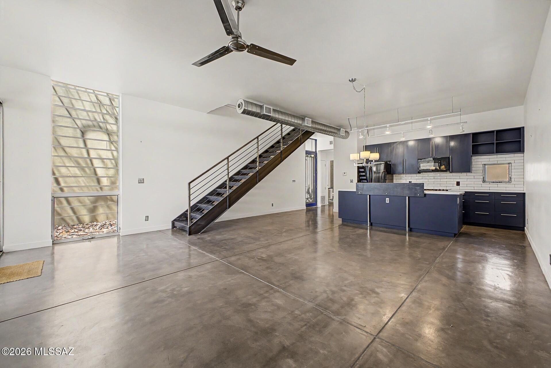 3605 East 3rd Street Tucson, AZ 85716 - Photo 10 of 39 Open concept dining/living areas with several floor to ceiling windows and access to the backyard.