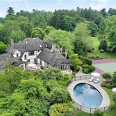 an aerial view of a house with yard swimming pool and outdoor seating