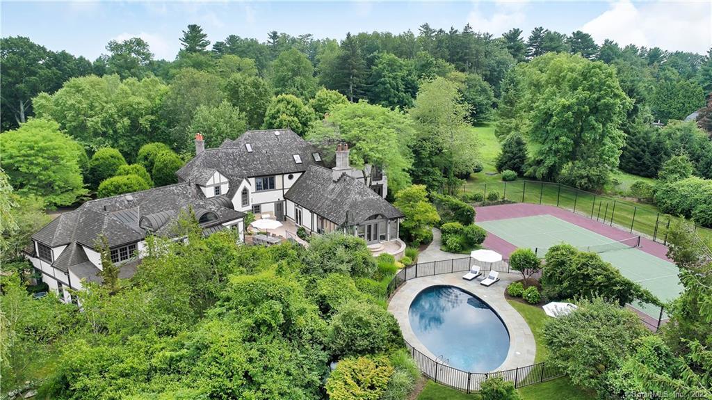 an aerial view of a house with yard swimming pool and outdoor seating