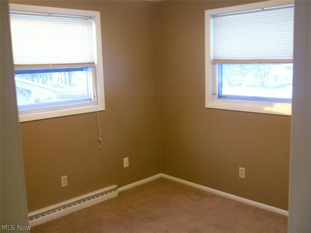 4619 15th Street Northwest Canton, OH 44708 - Photo 10 of 26 Empty room featuring a baseboard radiator and carpet floors