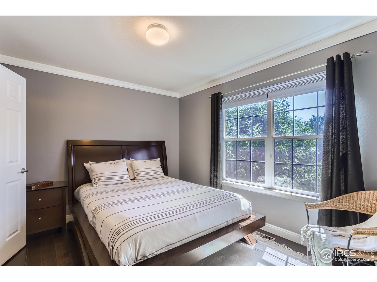 6626 Silverleaf Avenue Firestone, CO 80504 - Photo 14 of 27 a bedroom with a large bed and a large window