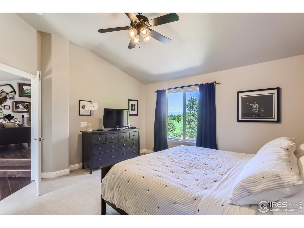 6626 Silverleaf Avenue Firestone, CO 80504 - Photo 16 of 27 a bedroom with a bed and a flat screen tv