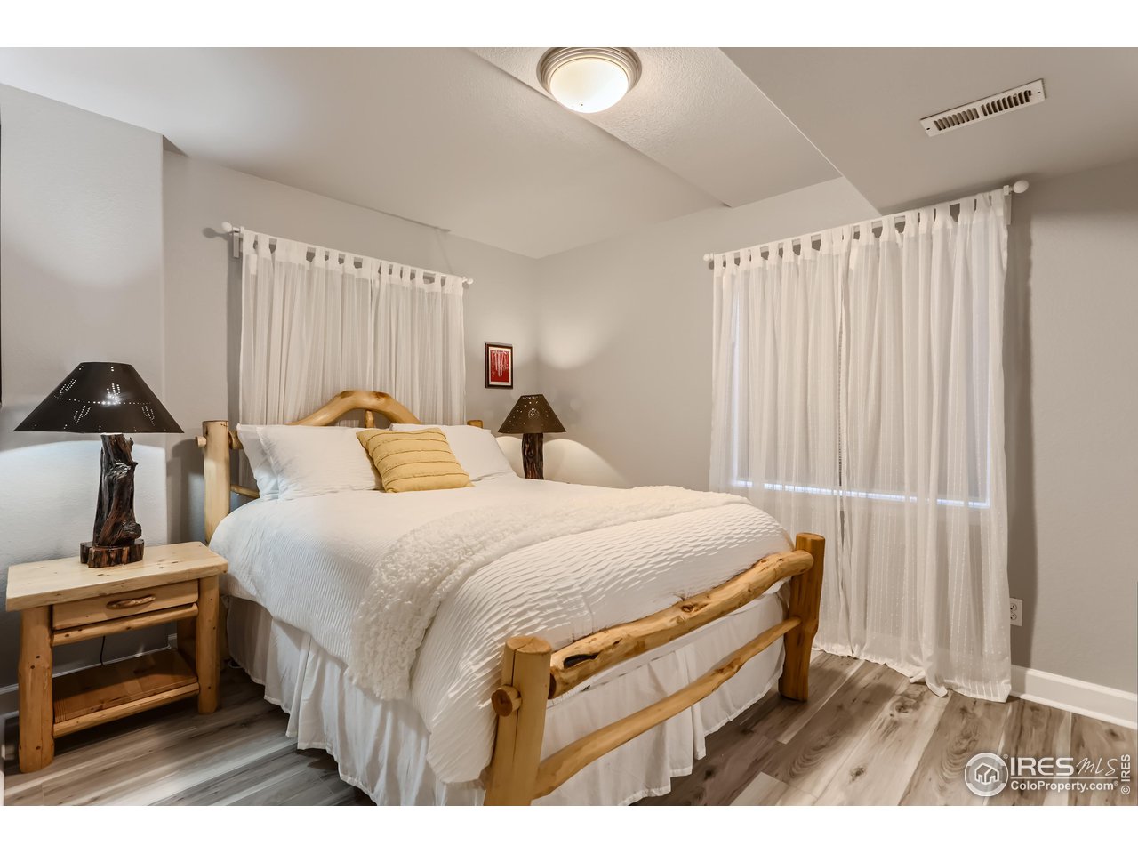 6626 Silverleaf Avenue Firestone, CO 80504 - Photo 22 of 27 a bedroom with a bed and a night stand