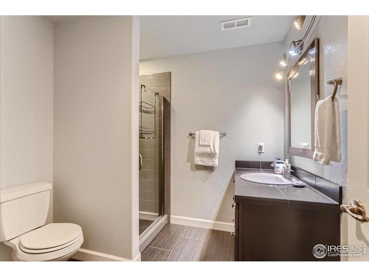 6626 Silverleaf Avenue Firestone, CO 80504 - Photo 23 of 27 a bathroom with a sink a toilet a mirror and shower