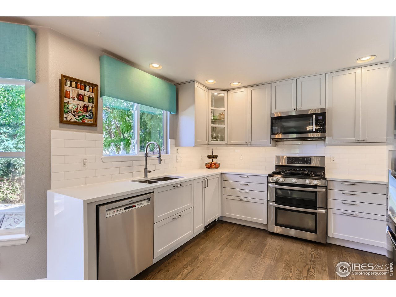 6626 Silverleaf Avenue Firestone, CO 80504 - Photo 3 of 27 a kitchen with stainless steel appliances granite countertop a stove a sink and a microwave
