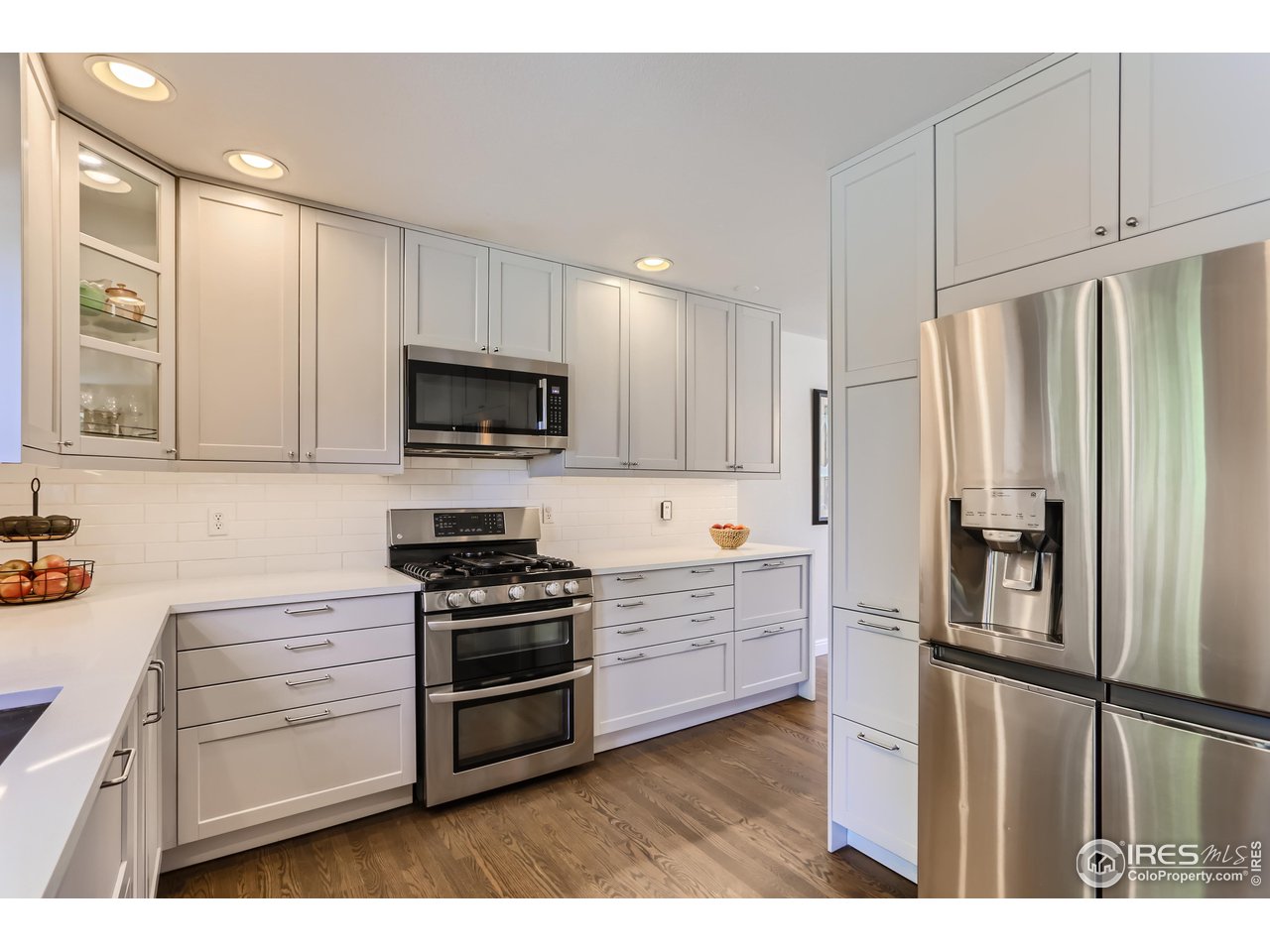 6626 Silverleaf Avenue Firestone, CO 80504 - Photo 4 of 27 a kitchen with granite countertop a refrigerator stove and microwave