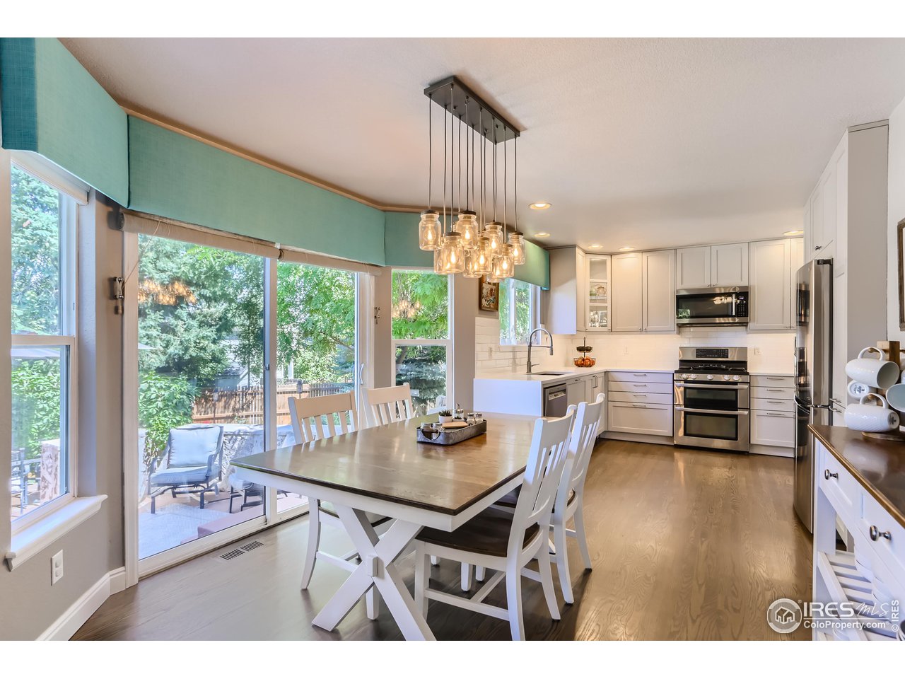 6626 Silverleaf Avenue Firestone, CO 80504 - Photo 6 of 27 a dining room with furniture a chandelier and wooden floor
