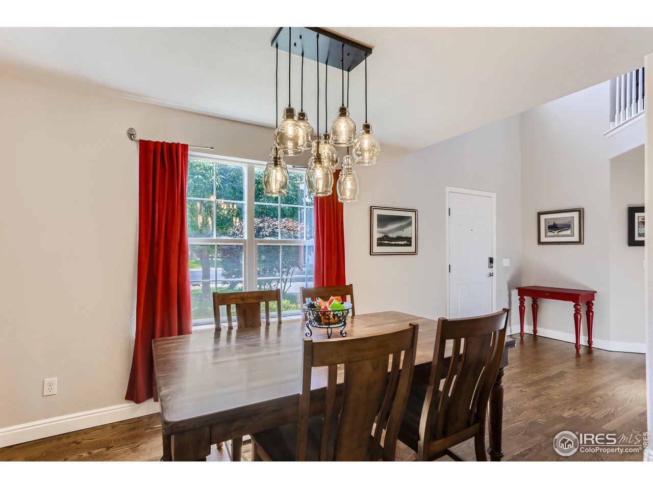 6626 Silverleaf Avenue Firestone, CO 80504 - Photo 7 of 27 a view of a dining room with furniture a chandelier and wooden floor