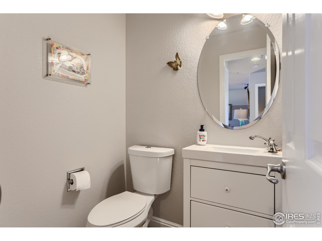 6626 Silverleaf Avenue Firestone, CO 80504 - Photo 8 of 27 a bathroom with a toilet a sink and mirror