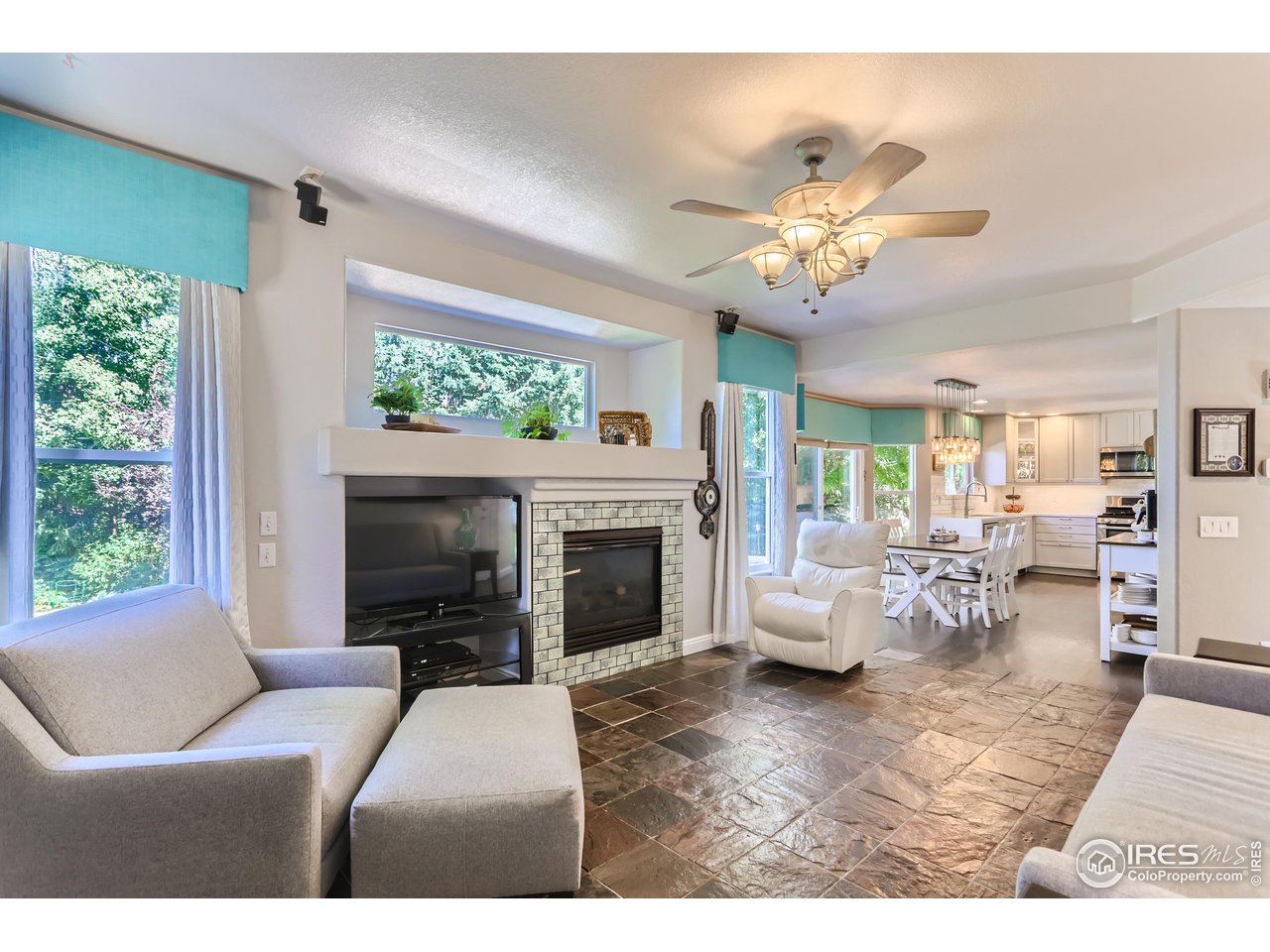 6626 Silverleaf Avenue Firestone, CO 80504 - Photo 9 of 27 a living room with furniture a fireplace and a chandelier