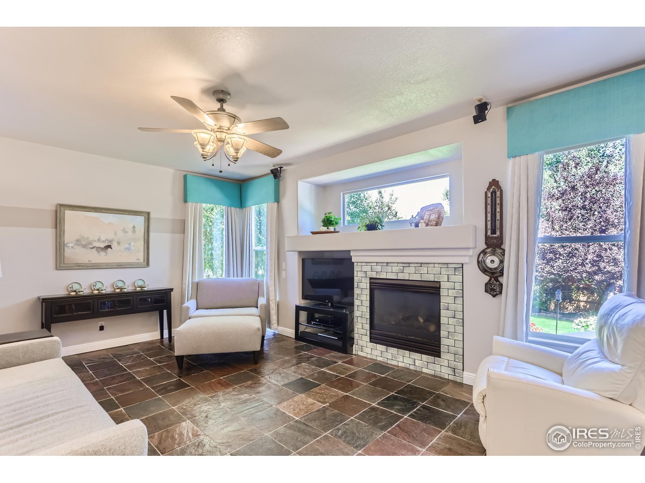 6626 Silverleaf Avenue Firestone, CO 80504 - Photo 10 of 27 a living room with furniture a window and a fireplace