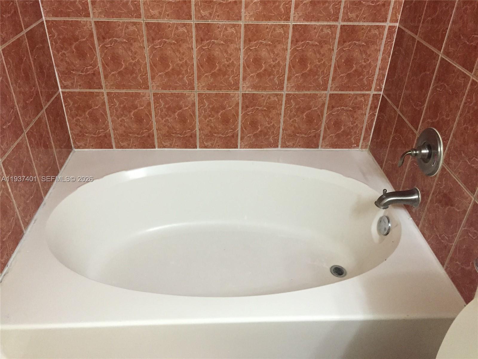 10441 Southwest 156th Court, Unit 421 Miami, FL 33196 - Photo 23 of 36 a bathroom with a bathtub