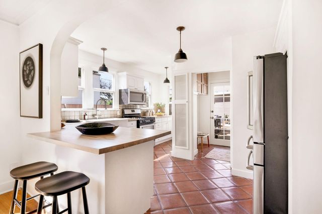 a kitchen with a sink stove and microwave