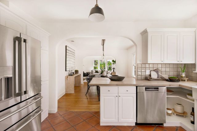 a kitchen with a sink cabinets and a window
