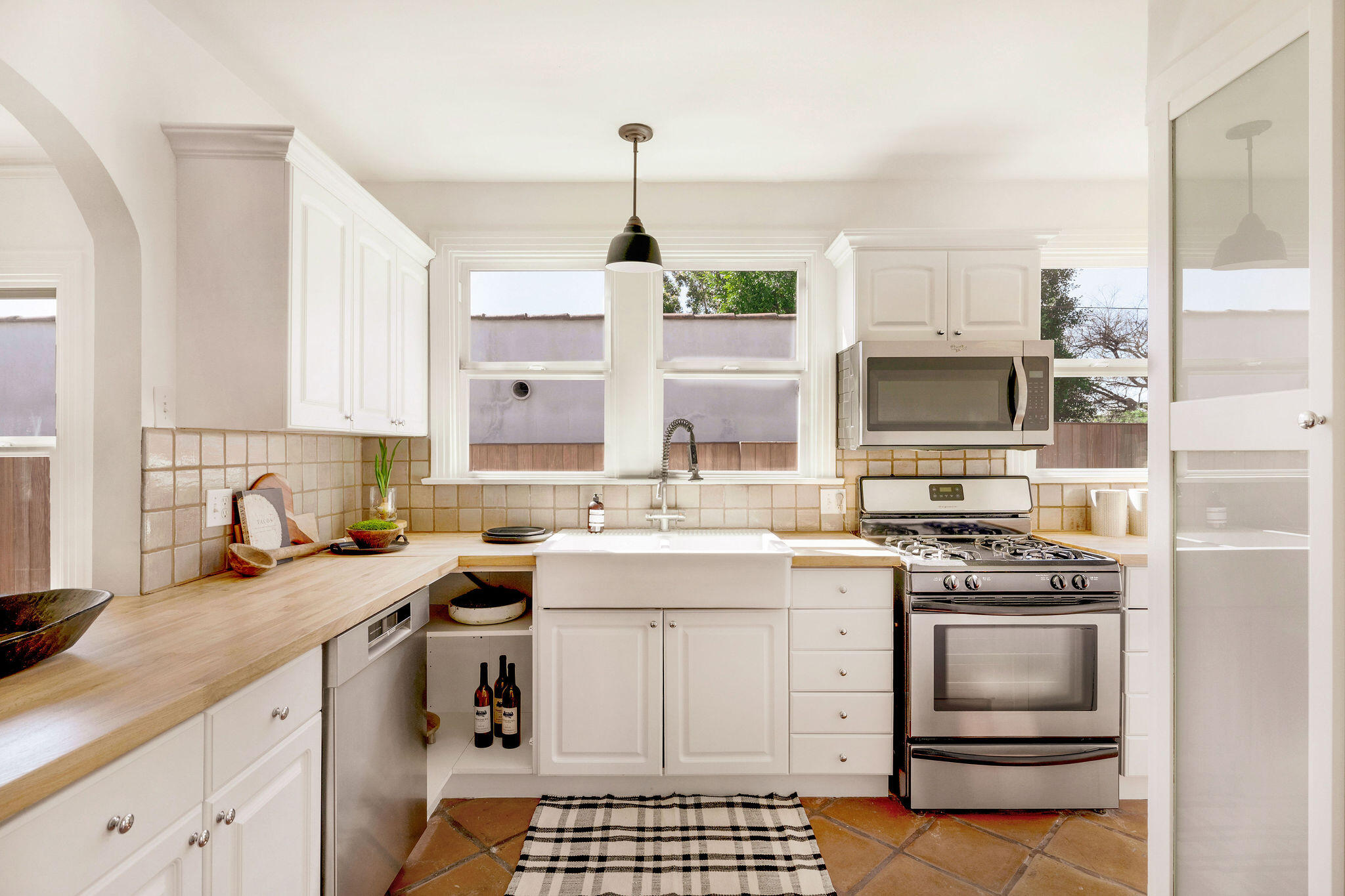 1317 Keniston Avenue Los Angeles, CA 90019 - Photo 17 of 57 a kitchen with a sink stove and microwave