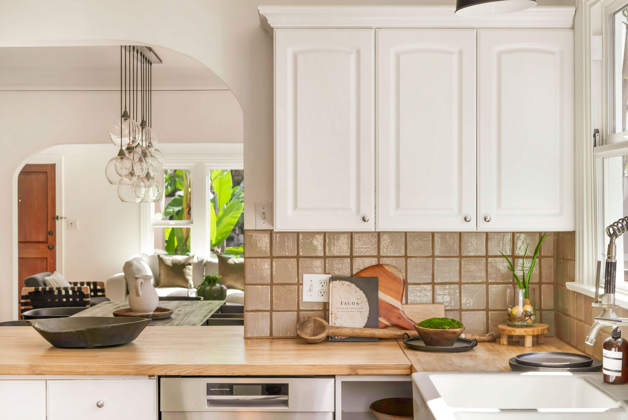 1317 Keniston Avenue Los Angeles, CA 90019 - Photo 18 of 57 a kitchen with a sink cabinets and a window
