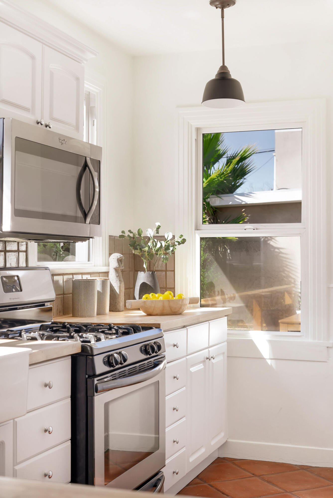 1317 Keniston Avenue Los Angeles, CA 90019 - Photo 19 of 57 a stove top oven sitting inside of a kitchen