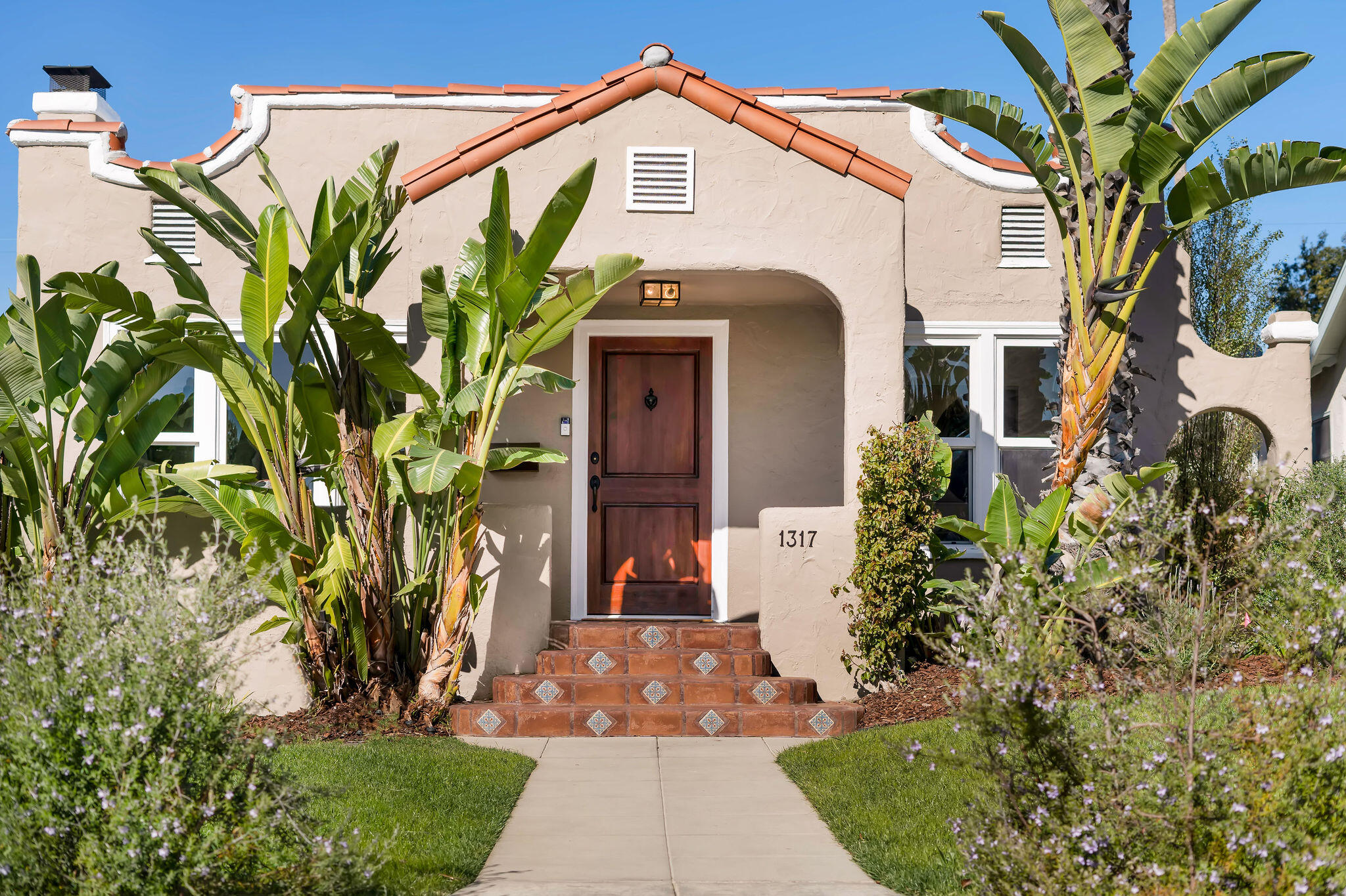 1317 Keniston Avenue Los Angeles, CA 90019 - Photo 2 of 57 a front view of a house with garden