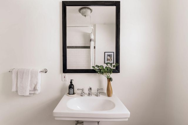 a bedroom with furniture and a large window