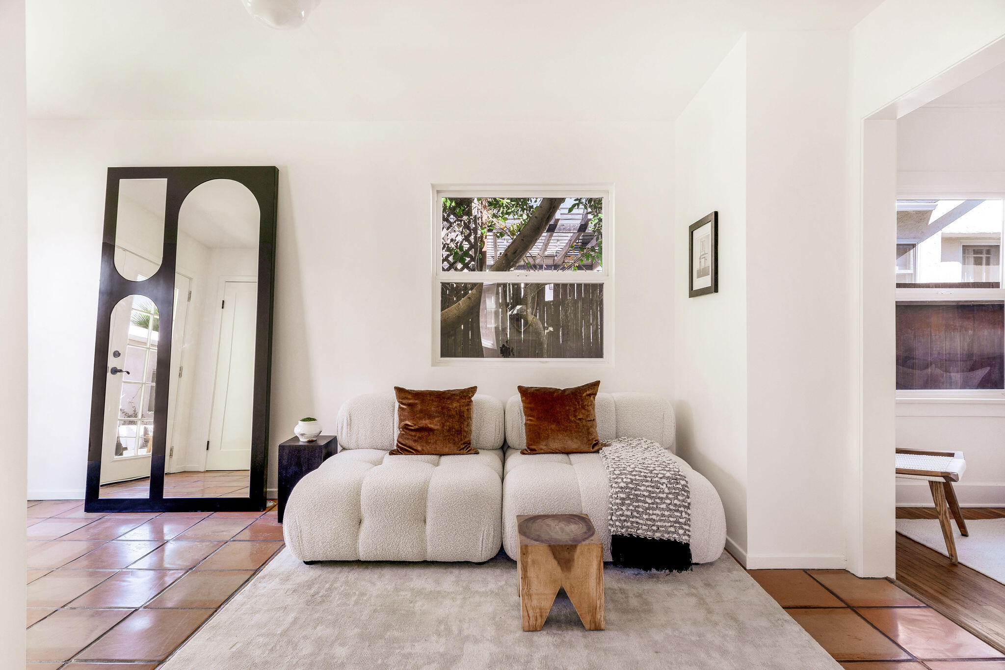 1317 Keniston Avenue Los Angeles, CA 90019 - Photo 31 of 57 a bedroom with a bed a mirror and a potted plant