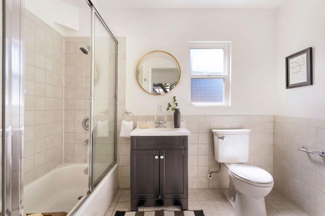 a kitchen with a stove a refrigerator and wooden floor