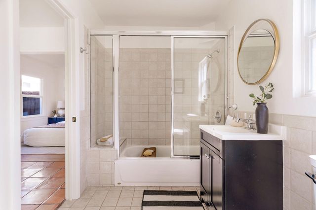 a view of a patio with a dining table and chairs with wooden floor