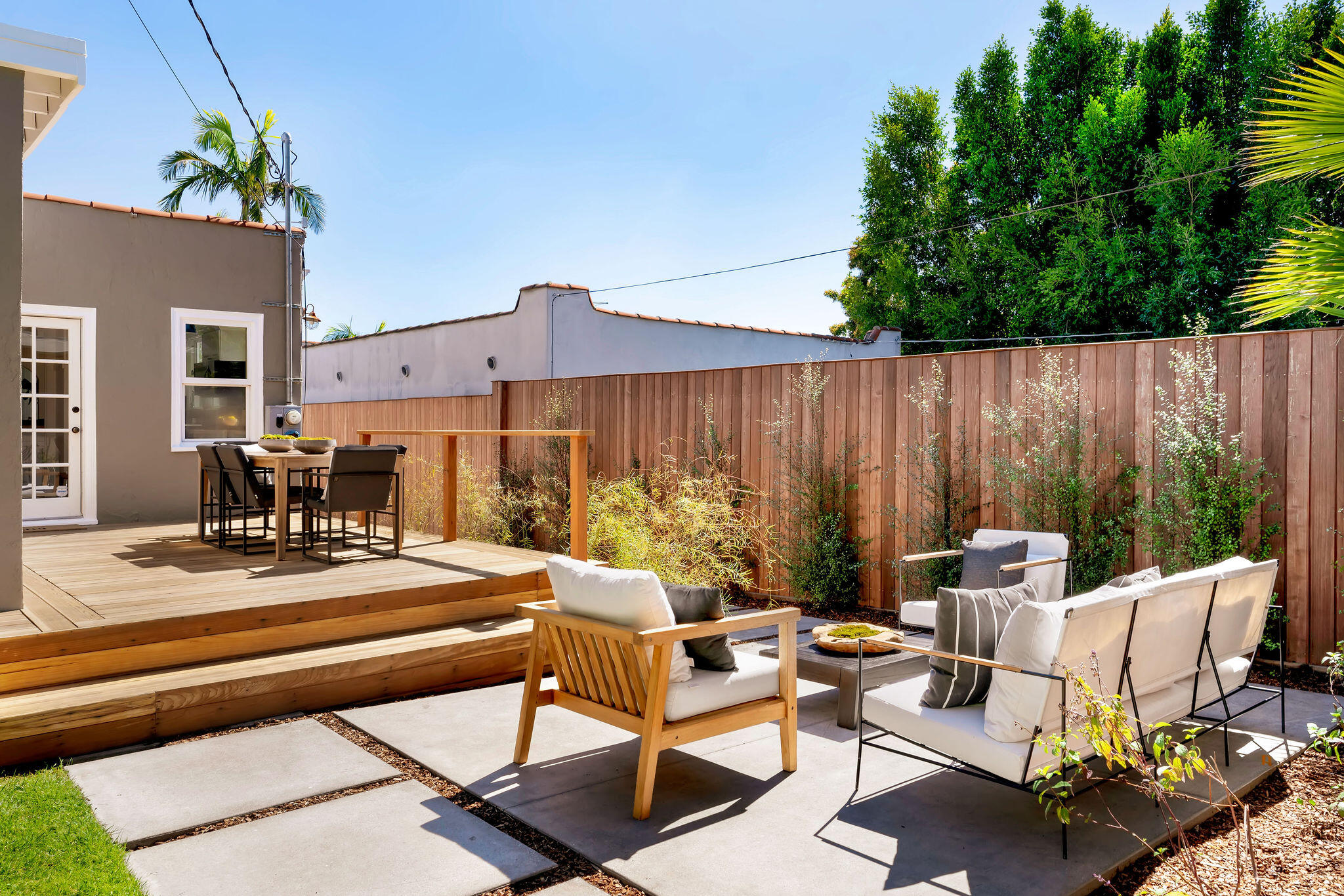 1317 Keniston Avenue Los Angeles, CA 90019 - Photo 35 of 57 a view of a patio with a dining table and chairs with wooden floor