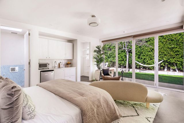 a kitchen with stainless steel appliances granite countertop a sink a stove and cabinets