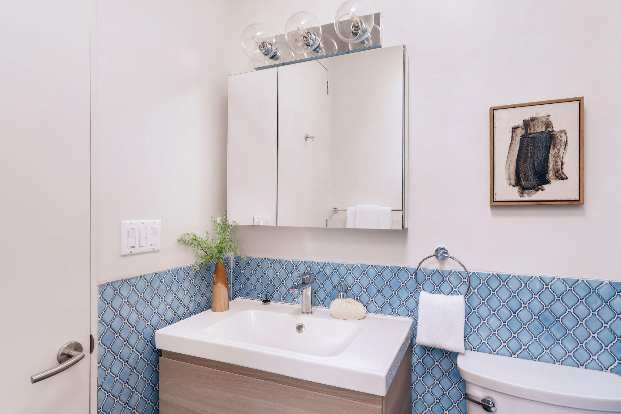 1317 Keniston Avenue Los Angeles, CA 90019 - Photo 49 of 57 a bathroom with a sink and a mirror