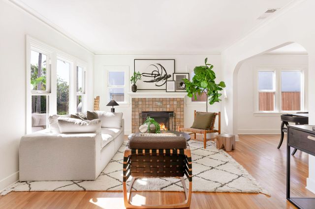 a living room with furniture a fireplace and a table