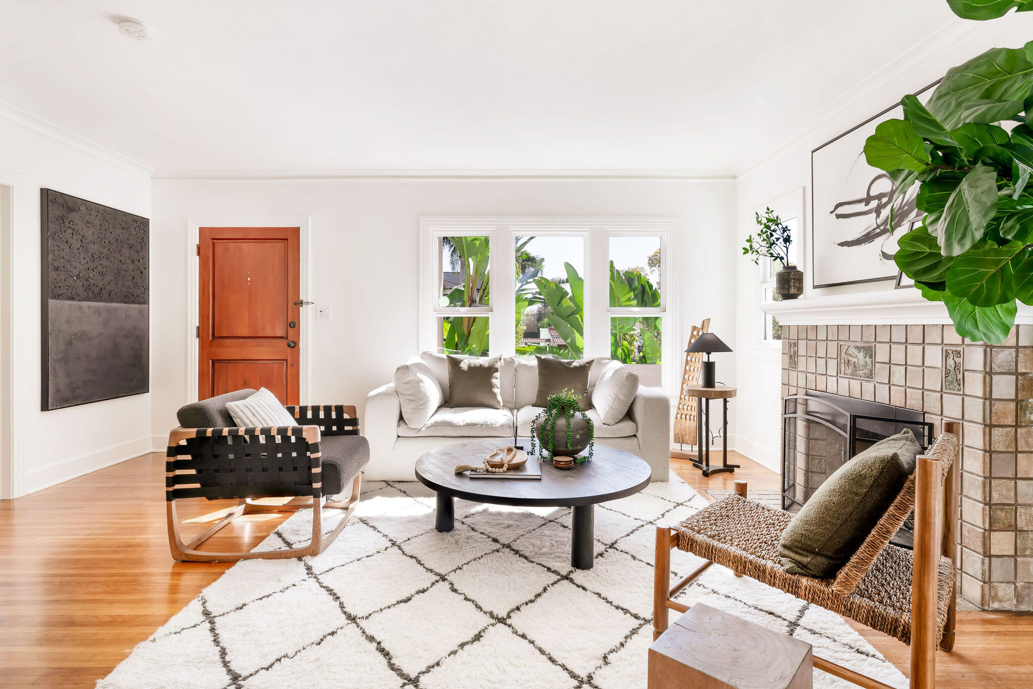 1317 Keniston Avenue Los Angeles, CA 90019 - Photo 7 of 57 a living room with furniture a fireplace and a large window