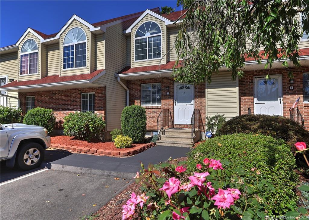 78 Pierpont Road, Unit 2C Waterbury, CT 06705 - Photo 1 of 1 a front view of a house with a yard and garage