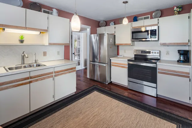 a kitchen with a sink cabinets and stainless steel appliances