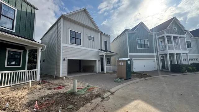 a view of a house with a yard and garage